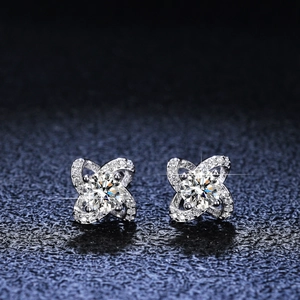 Macro detail of silver four-leaf clover earrings with brilliant moissanite stones