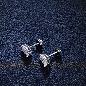 Macro shot of oval cut clear stone earrings in a polished four-prong silver setting