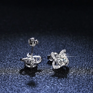 Macro shot of clover-shaped S925 silver studs with moissanite pave detail