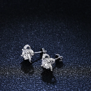 Macro shot of S925 silver four-leaf clover moissanite earrings with fine diamond setting