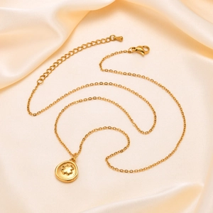 18K gold-plated stainless steel four-leaf clover necklace on silk cream background