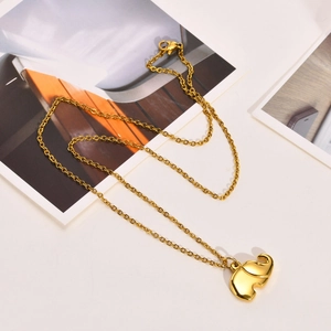 Close-up of a polished gold elephant pendant necklace with delicate link chain
