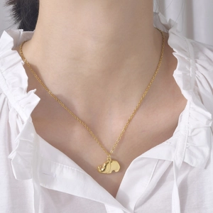 Elegant gold-plated stainless steel elephant pendant necklace worn by a female model
