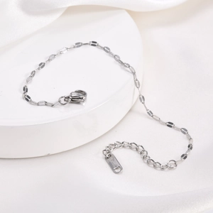 Detail of silver stainless steel chain bracelet with lobster clasp and S.STEEL tag