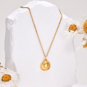 Elegant 18K gold stainless steel necklace with clover pendant on white stone background