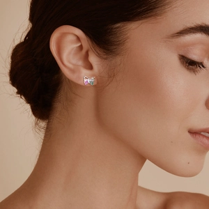 Macro shot of silver butterfly stud earrings set with colorful sparkling zircon stones