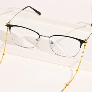 Detail of semi-rimless glasses with a gold beaded stainless steel lobster clasp chain
