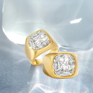 Polished gold-plated square-cut white stone rings on a blue ice-themed background