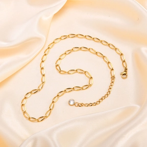 Detail of 18K gold-plated paperclip chain with lobster clasp and round zircon charm