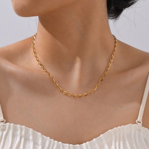 Close-up of minimalist 18K gold-plated stainless steel chain necklace worn on the neck