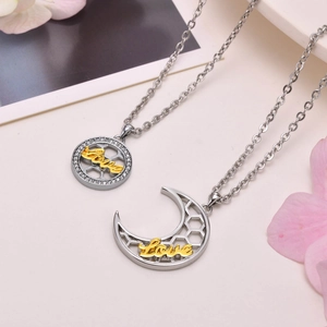 Detail of sun and moon couple necklaces featuring Love script and zircon stones