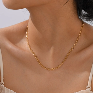 Elegant 18K gold-plated stainless steel chain necklace worn by a model on a warm skin tone