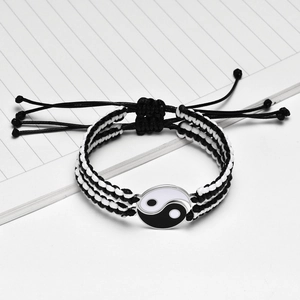 Detail of hand-woven Yin Yang bracelet with magnetic heart and adjustable cord closure