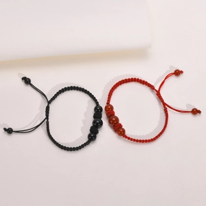 Macro view of woven ropes with black and red onyx beads and adjustable drawstring closure