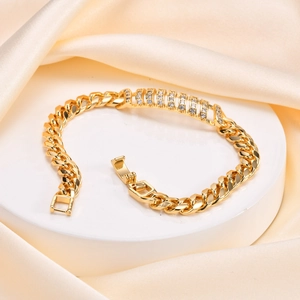 Close-up of gold plated Cuban chain bracelet with paved zircon stones and folding clasp
