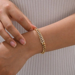 Detailed view of women's gold-plated Cuban link bracelet with sparkling cubic zirconia pavé