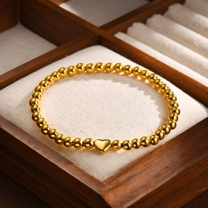 Polished gold stainless steel bead bracelet with heart pendant in a premium wooden box