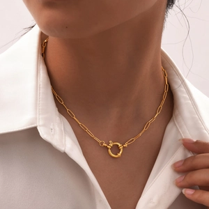 Close-up of 18K gold-plated paperclip chain necklace with round spring buckle on a model