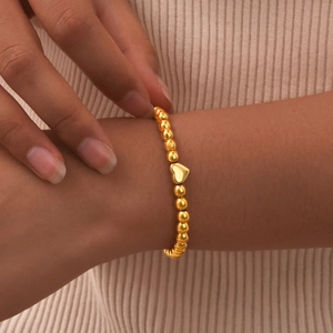 Elegant gold beaded stainless steel bracelet with a polished 3D heart pendant for women