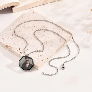 Detail of custom octagonal pendant necklace featuring personalized portrait on stone slab