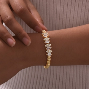 Detailed close-up of a luxury gold-plated Cuban bracelet with marquise-cut zircons on wrist