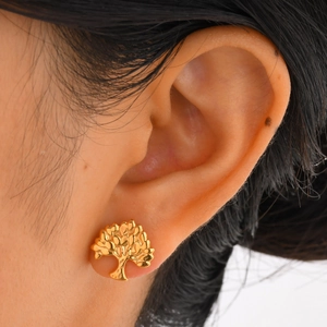 Golden Tree of Life stainless steel stud earrings on model for women's fashion