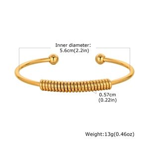 Detail view of gold stainless steel spring cuff bracelet with size and weight metrics