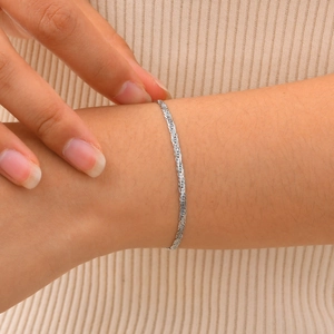 Minimalist silver woven rope chain bracelet in stainless steel on female wrist