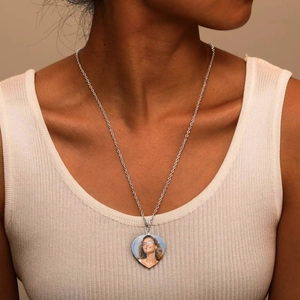 Custom silver heart locket necklace with personalized photo worn by model