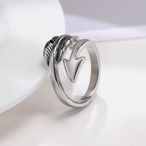 Macro shot of silver feather and arrow ring with vintage textured details