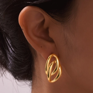 Detailed view of women's gold oval double-loop earrings with a polished mirror finish