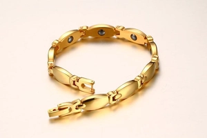 Detailed macro view of the gold-plated magnetic health bracelet with polished links