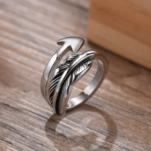 Macro detail of vintage stainless steel feather ring showing textured black detailing