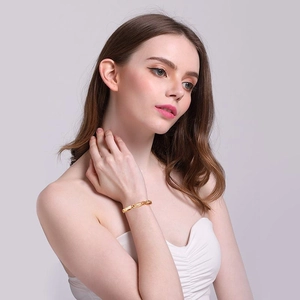 Close-up of 18K gold-plated stainless steel magnetic bracelet worn by a model