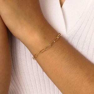 Minimalist gold paperclip chain bracelet for women shown on wrist with sleek metal finish