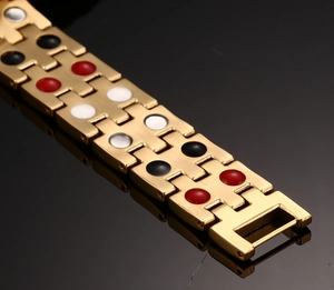 Macro shot of gold stainless steel magnetic bracelet with dual row mineral stones