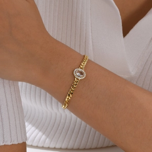 Macro shot of gold-plated copper bracelet featuring an oval zircon center and halo accents