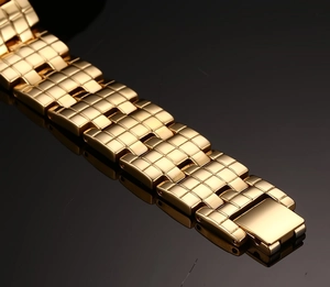 Detailed close-up of a gold-plated stainless steel men's bracelet with a grid texture
