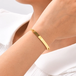 Detailed close-up of a minimalist gold bar bracelet on a model's wrist for daily wear