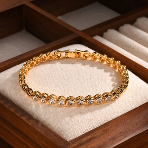 Macro detail of gold-plated zircon bracelet with hexagonal link settings and secure clasp