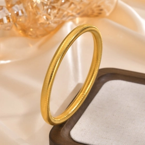 Minimalist 14K gold plated stainless steel textured round bangle for women on tray