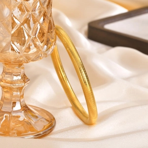 Polished 14K gold-plated stainless steel bangle with fine snake-textured ribbed finish