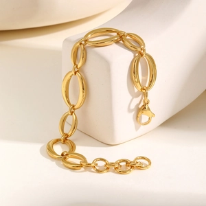 Detail view of bold gold chunky chain bracelet with oval links and lobster clasp finish