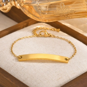 Macro shot of gold curved metal plate and adjustable chain in a premium display box