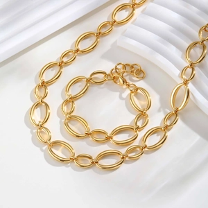 Polished 18K gold plated oval link chain necklace and bracelet set on white display