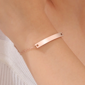 Close-up of a polished rose gold bar bracelet on a wrist for a minimalist jewelry look