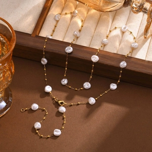 Detailed close-up of Baroque pearl Y-necklace with gold-plated stainless steel chain