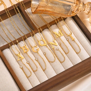 Gold plated stainless steel letter necklace with small zircon charm on cross chain
