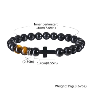 Detail of beaded bracelet with black onyx, tiger eye stones and cross charm