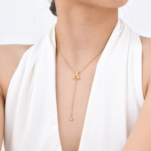 Golden Y-shaped necklace with letter A pendant and sparkling cubic zirconia tassel